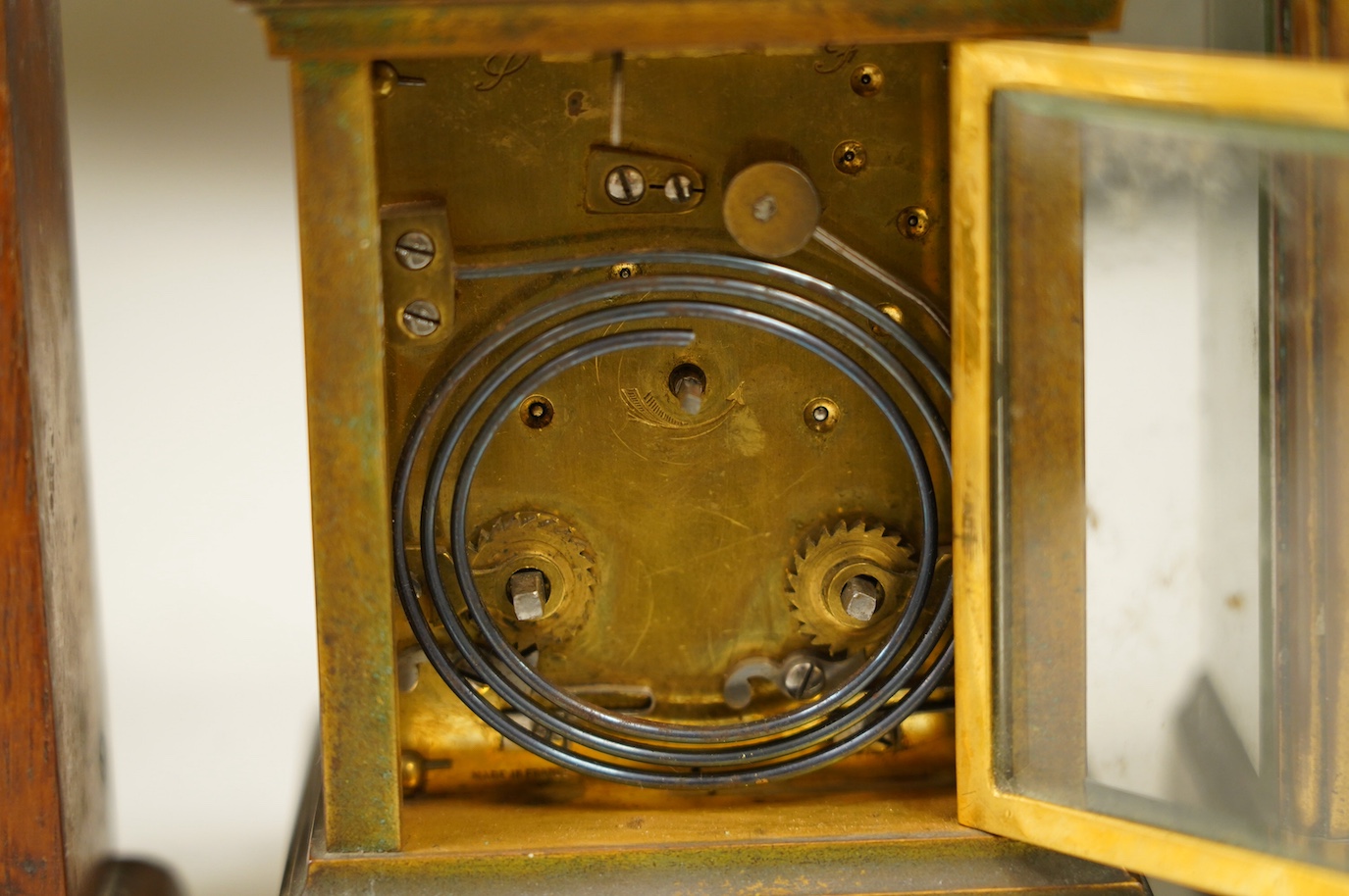 Two carriage clock, an Edwardian mantel clock, 25cm high, and a watch mounted in an oak case (4). Condition - fair, not tested for working